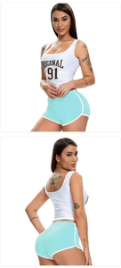 Detail showing white tank top with 'ORIGINAL 91' text and mint green athletic shorts
