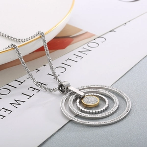 Close-up of two-tone stainless steel layered circles pendant necklace with rhinestones