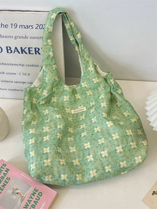 Floral print green tote bag featuring minimalist lotus patterns and tie straps for daily use