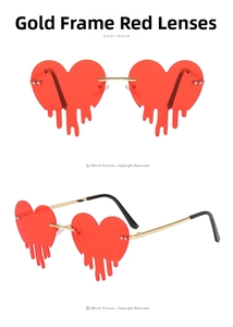 Close-up of gold metal frame with red heart-shaped lenses and fluid drop design