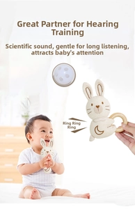 Detail of baby crochet bunny rattle with natural wooden ring for sensory grasping