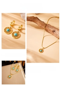 Close-up of gold sunburst jewelry set with turquoise stones and snake chain detail
