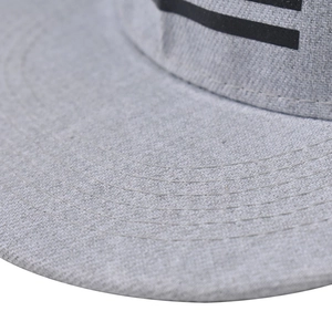 Detail shot of grey flat brim hip hop hat showing precise multi-row stitching on the visor