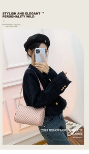 Close-up of pink barrel shoulder bag with vintage pattern and sleek leather strap
