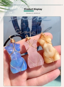 Detailed view of handmade crystal goddess torso pendants wrapped in gold wire with black cords
