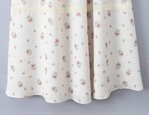Close-up of floral print fabric with lace trim and polka dots on a summer dress