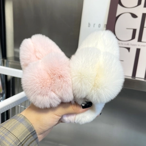Close-up of soft faux fur hair claw clips in pink and white colors for winter styling