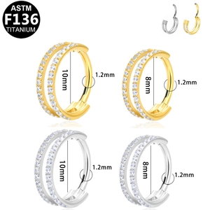 Macro view of ASTM F136 titanium double-row zircon hoops in silver and gold finishes