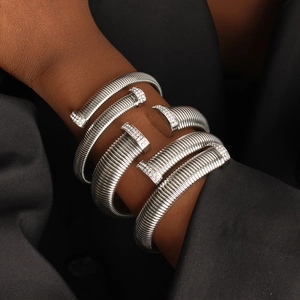 Silver spiral cuff bracelet with sparkling zircon accents on an elegant female model