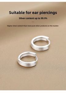 Macro view of 999 sterling silver hoop earrings with a brushed matte finish detail