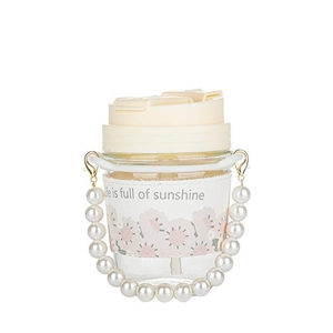 Floral glass tumbler with pearl handle and Life is Full of Sunshine sleeve in studio light