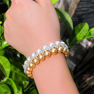 Double-layered pearl bracelet with zircon accents shown on a model in nature