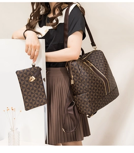 Close-up of brown geometric print backpack and matching wristlet with gold hardware
