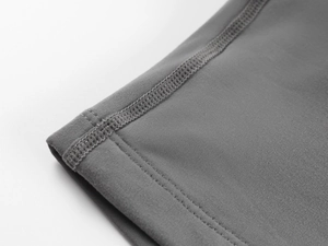 Macro shot of gray high-elastic knit fabric with precision four-needle six-thread stitching