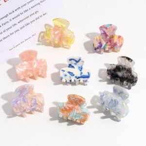 Set of 8 leopard print and gradient marble pattern hair claws on a clean white background