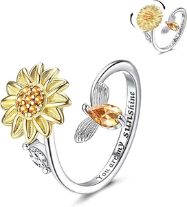 Detail of spinning sunflower ring with cubic zirconia and You are my sunshine engraving