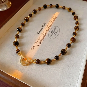 Collana vintage occhio di tigre con perline placcate oro e chiusura in cristallo