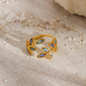 Vintage leaf open ring with iridescent enamel inlay on a natural stone background