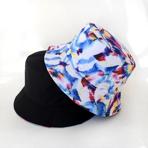 Detail of reversible bucket hat showing solid black and colorful oil painting print
