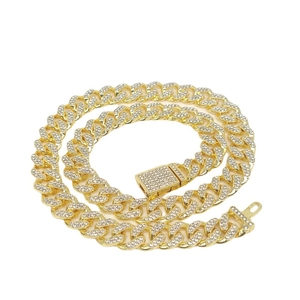 Luxurious 12mm iced out gold Cuban link chain necklace with sparkling crystals on white base