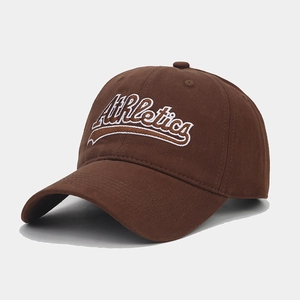 Detail of white Athletics embroidery on a dark brown vintage cotton baseball cap