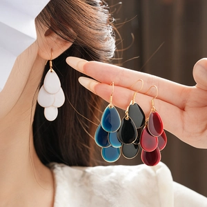 Close-up of colorful multi-layered teardrop earrings with elegant tassel design