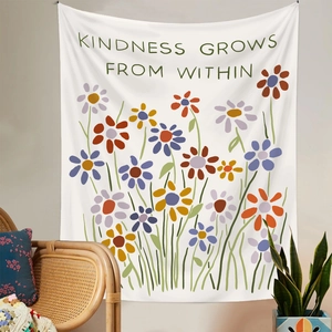 Detail of wall tapestry featuring floral patterns and Kindness Grows From Within slogan