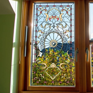 Art Nouveau stained glass window film with colorful floral patterns on a wooden frame