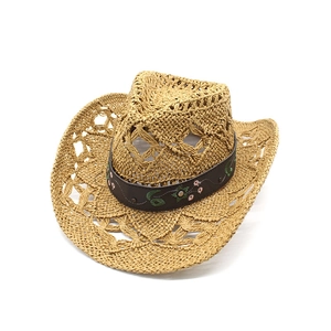 Detail of hand-woven straw cowboy hat featuring floral embroidery on a brown leather band