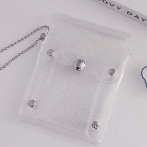 Macro detail of transparent PVC glitter card holder with silver ball chain and snap closure