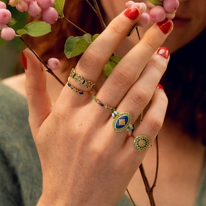 Close-up of S925 silver rings with colorful stones and evil eye motif on model hand