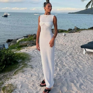 Detail of elegant chest twist knot on a white sleeveless maxi dress for beach vacations