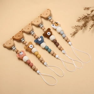 Handmade crochet bear pacifier clips with natural wooden beads in five soft pastel colors