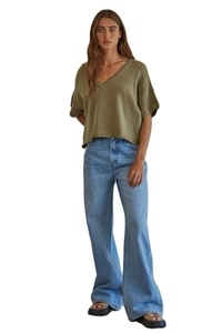 Detail of high waist wide leg jeans paired with olive green knit V-neck short sleeve top