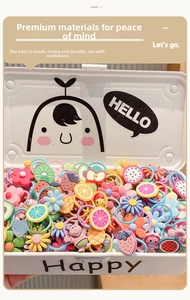Macro detail of children's hair bands with colorful fruit and animal charms in a storage box