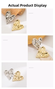 Detailed view of heart-shaped metal brooches featuring irregular hammered gold and silver textures