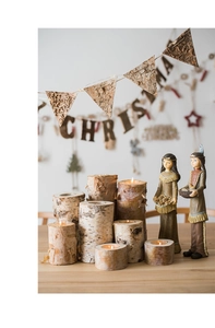 Close-up of natural birch wood candle holders with rustic texture for Christmas decor
