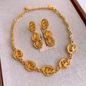 Baroque style gold flower jewelry set featuring a detailed necklace and drop earrings