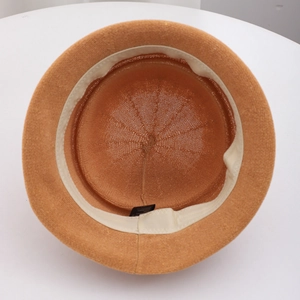 Detailed interior of woven caramel straw hat with sweatband and quality stitching