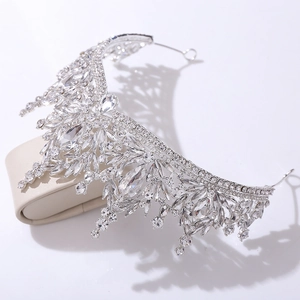 Close-up of bridal crystal tiara with intricate leaf design on silver metal base