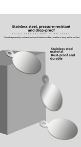 Close-up of smooth oval stainless steel pendant tags showing polished metallic texture