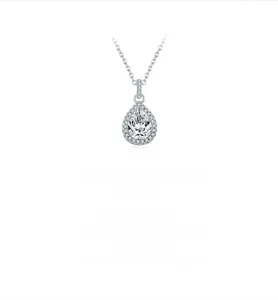 Macro detail of pear-shaped moissanite pendant with halo setting on a silver chain