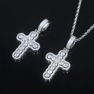 Macro view of silver-tone hollow cross pendant with sparkling zircon stones inlay