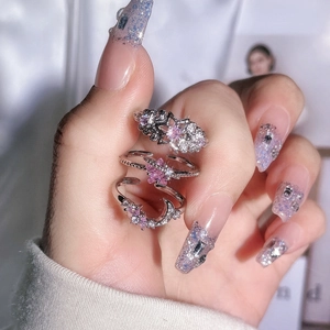 Detail of three rings set featuring star and crescent moon with pink zircon stones