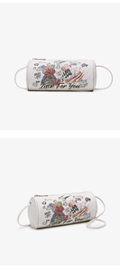 Detail showing colorful graffiti bear prints and leather texture on the cylinder bag