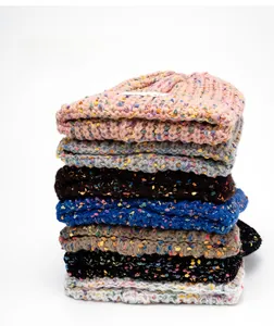 Detailed texture of thick knitted beanies in multiple colors and speckled yarn