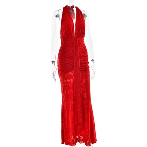 Detail of red halter neck dress featuring a deep V-neckline and intricate lace patterns