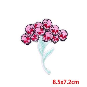 Detailed embroidery of floral skull patch with pink flowers, measures 8.5x7.2cm