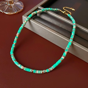 Detailed close-up of round turquoise beads and gold metal spacers on a vintage necklace