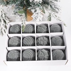 Close-up of 12 grey flocked Christmas balls with assorted textures in a gift box